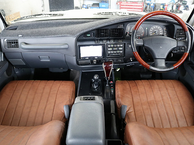 グレー内装の車内♪社外のウッドコンビステアが装着済！コンディションも良好で中期モデルはメーターパネルとエアコンパネルが一体になります♪こういった内装は古い車ならではなのでレトロな車が好きな方必見です♪