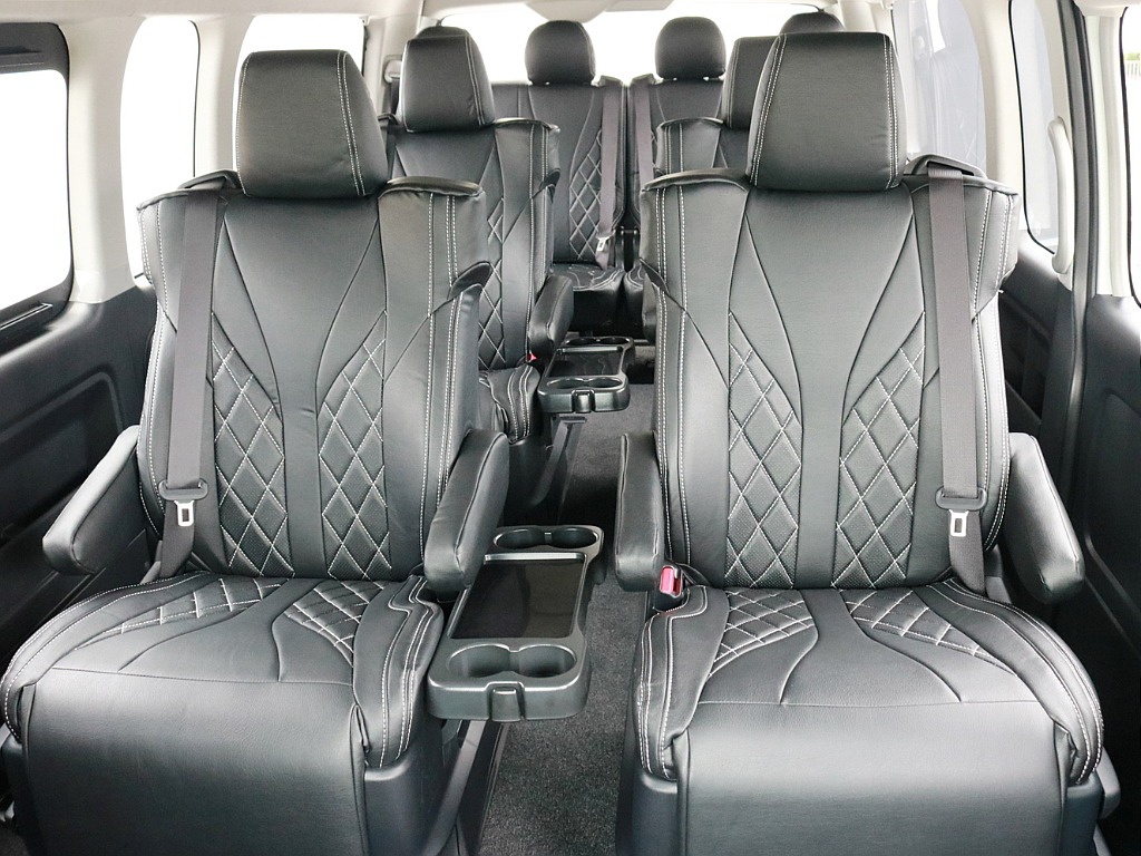 ファインテックツアラー後部座席の様子です。全席に専用のシートカバーが設置されています。2列目3列目シート中央部にあるドリンクホルダー付きテーブルを収納することによってウォークスルーが可能になります。
